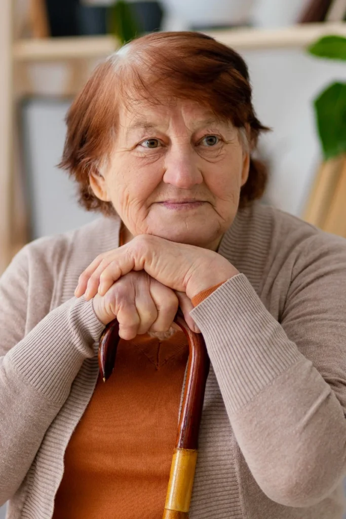 Portrait ältere Dame auf Gehstock gestützt